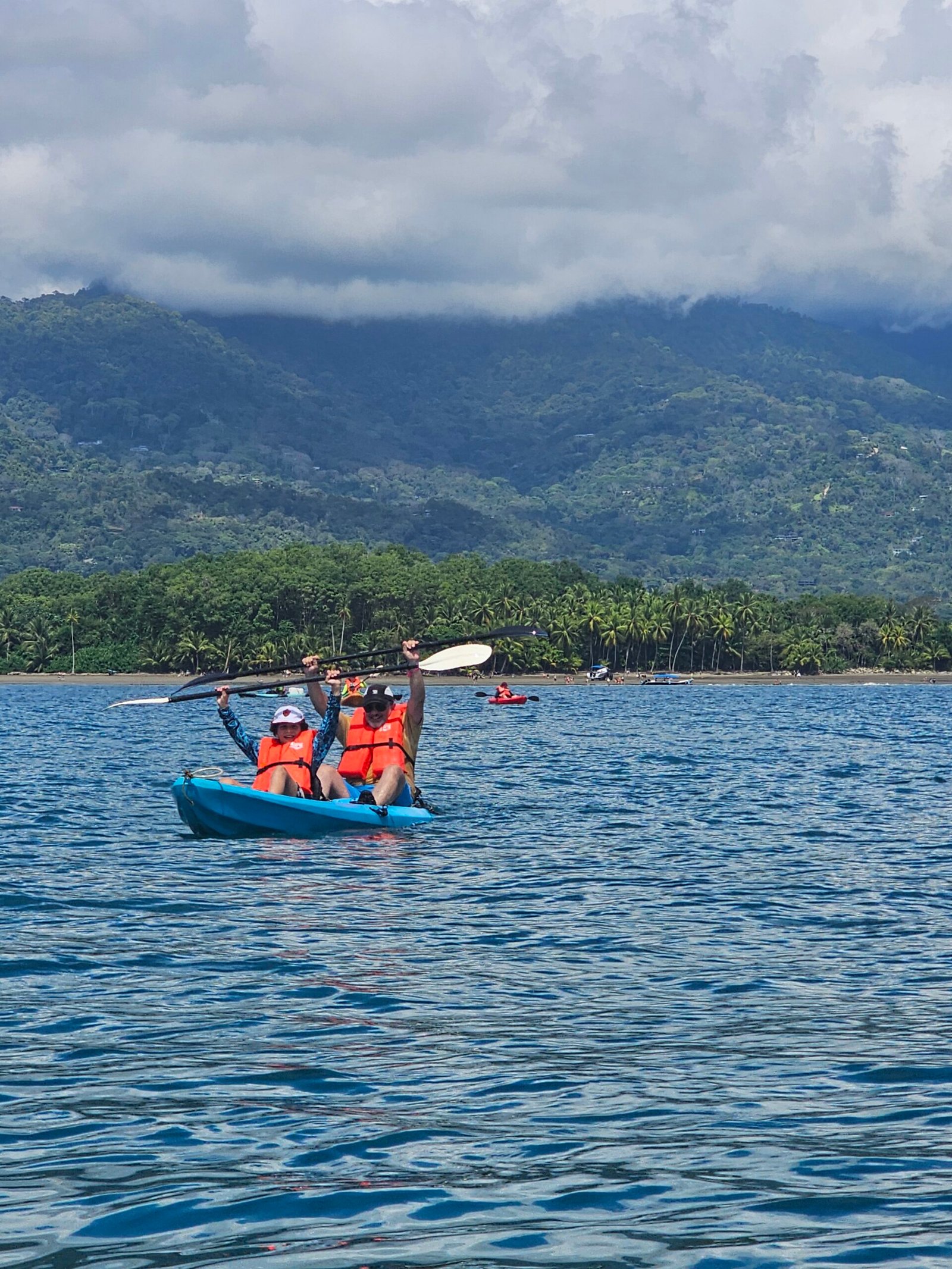 Guests kayaking with the coastal mountains behind them